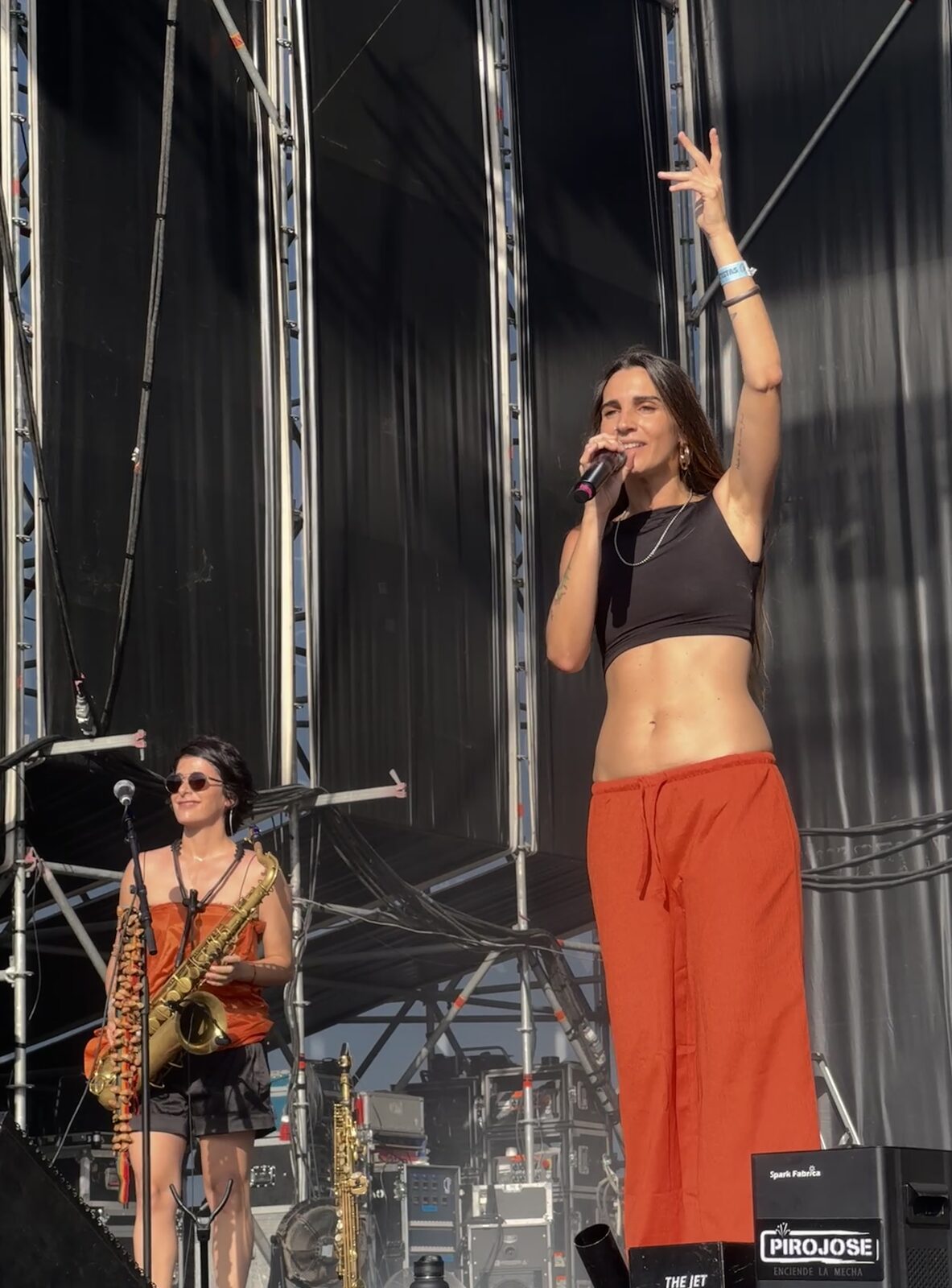 Carolina Araoz with her saxophone on an open-air stage